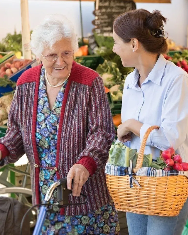 Always Responsive caregiver shopping for groceries with a senior client